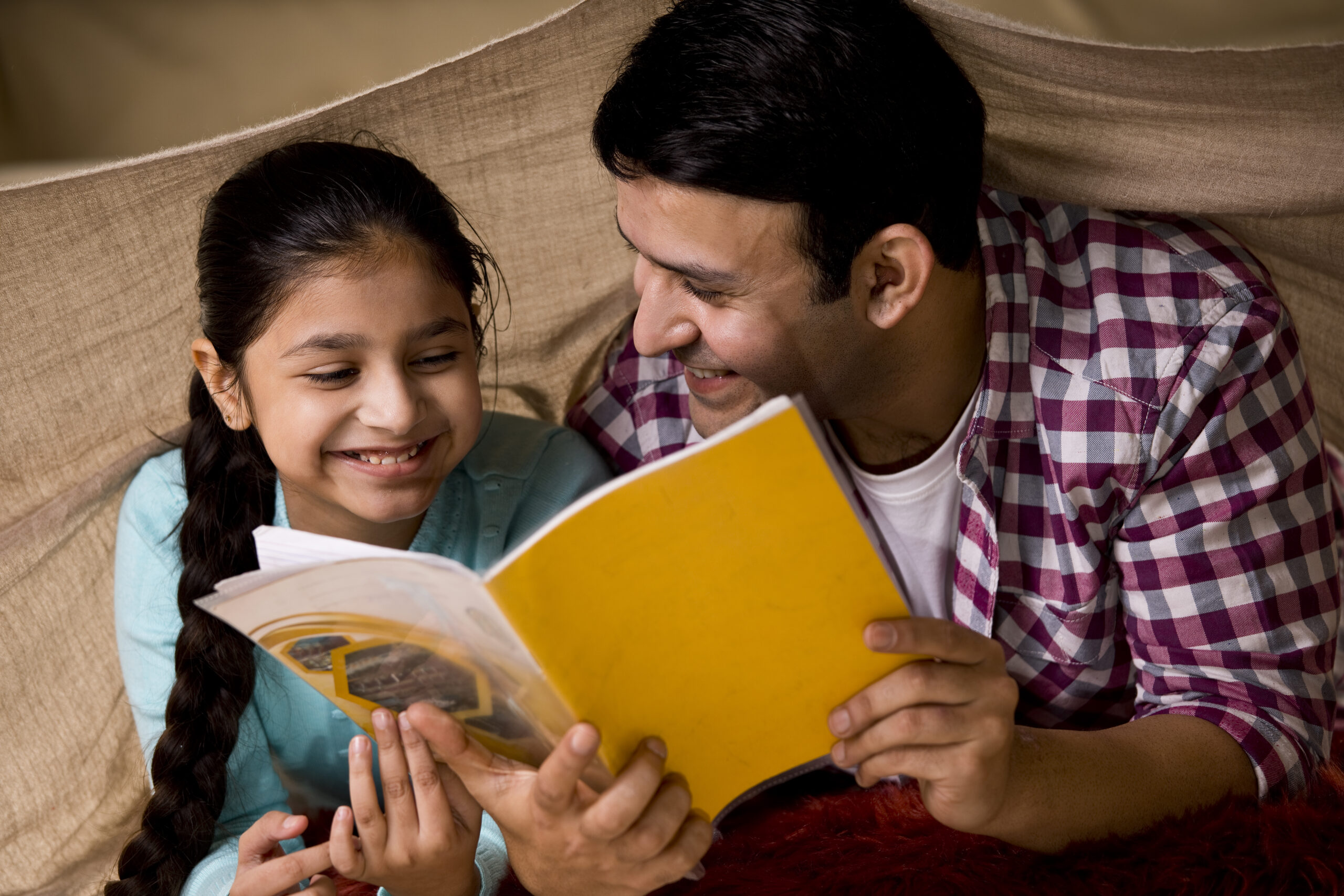 Father and daughter reading a book