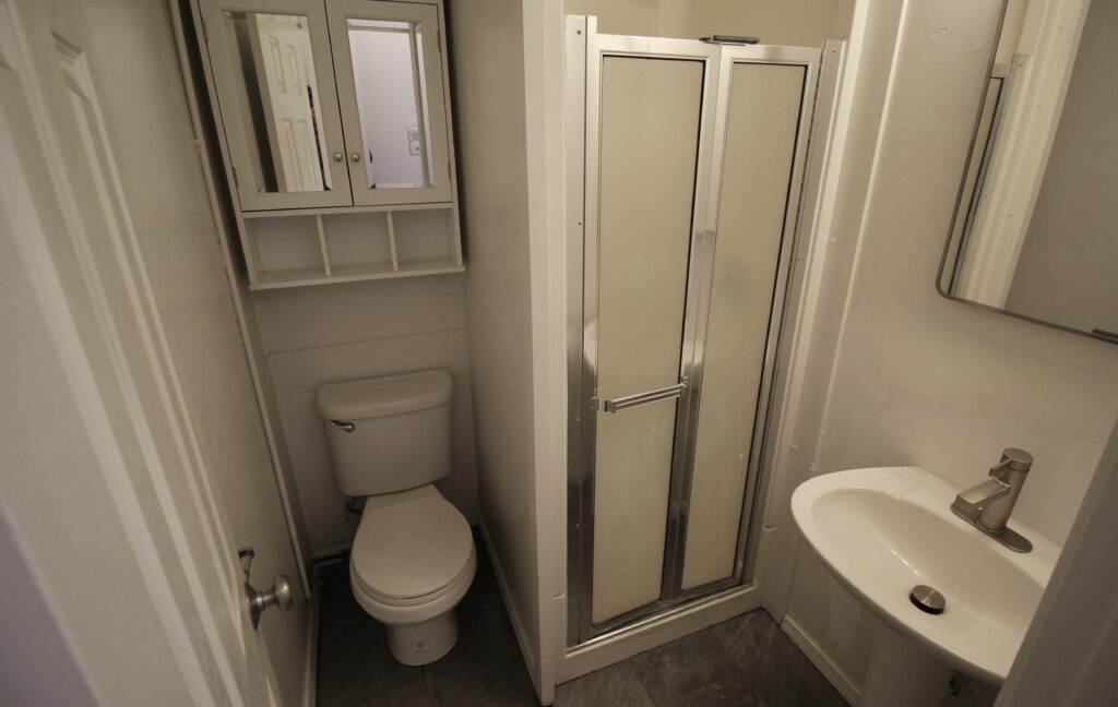 Small bathroom with shower and toilet.