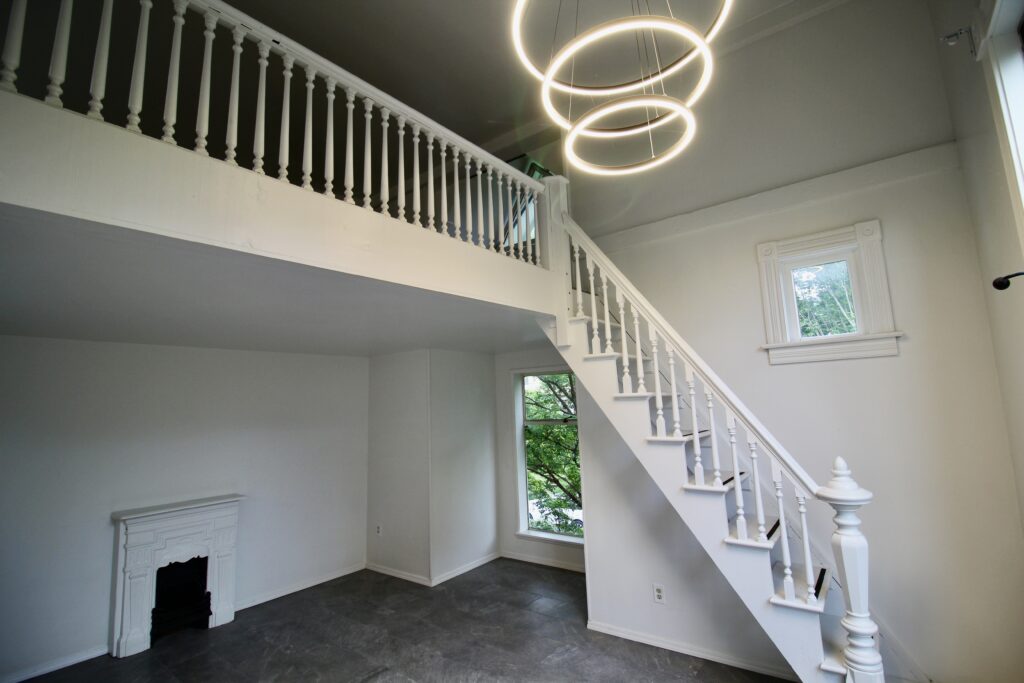 White loft interior with spiral light fixture.