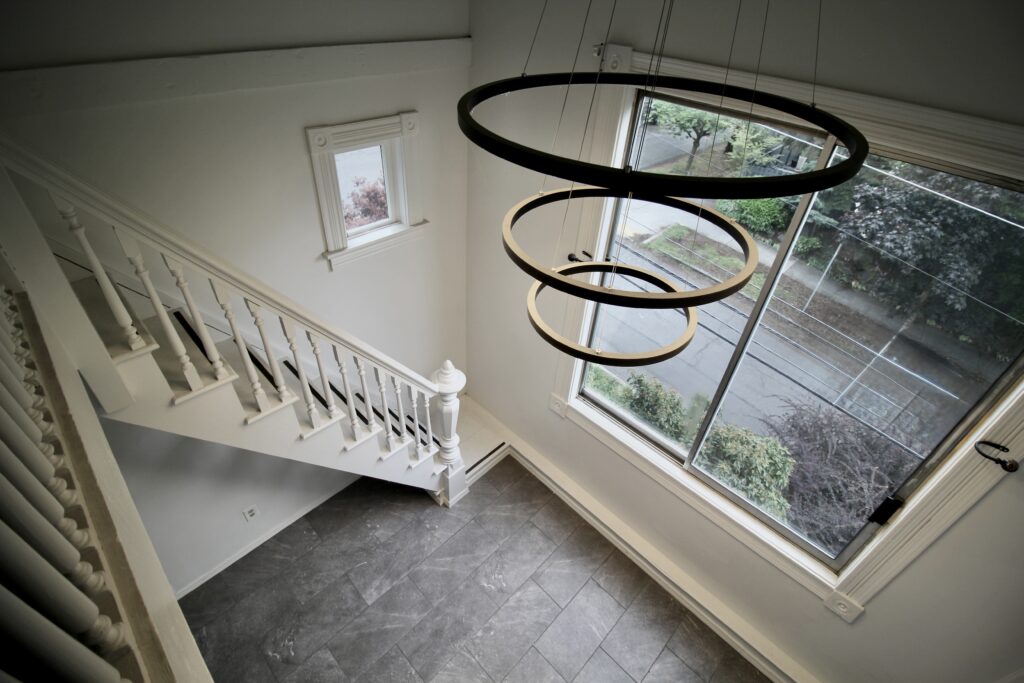 Modern staircase with circular ceiling light.